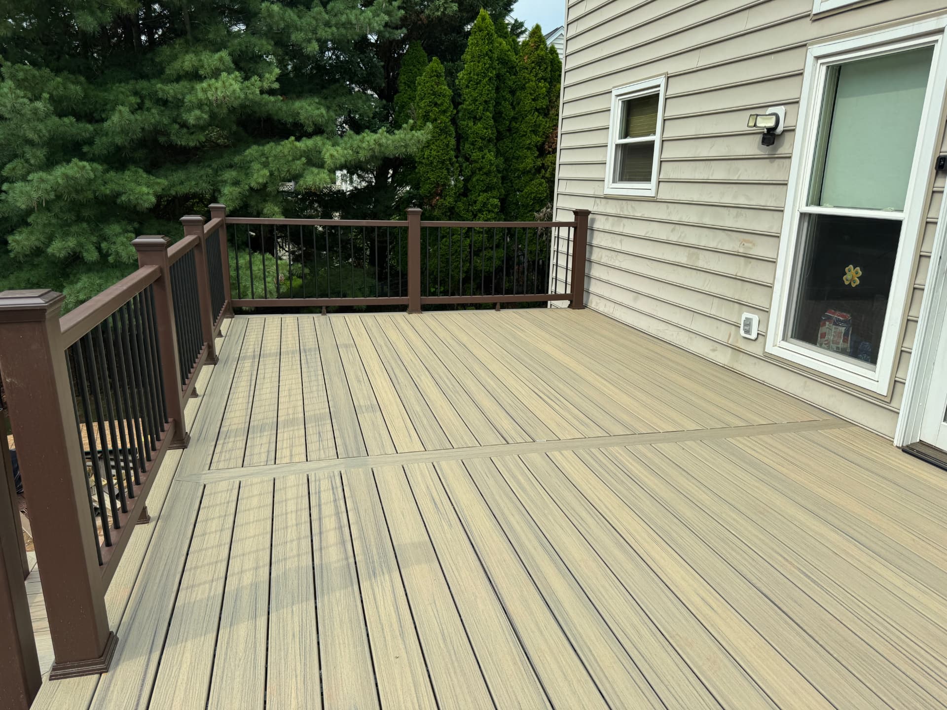 Close view of tan composite decking boards with a picture-frame border