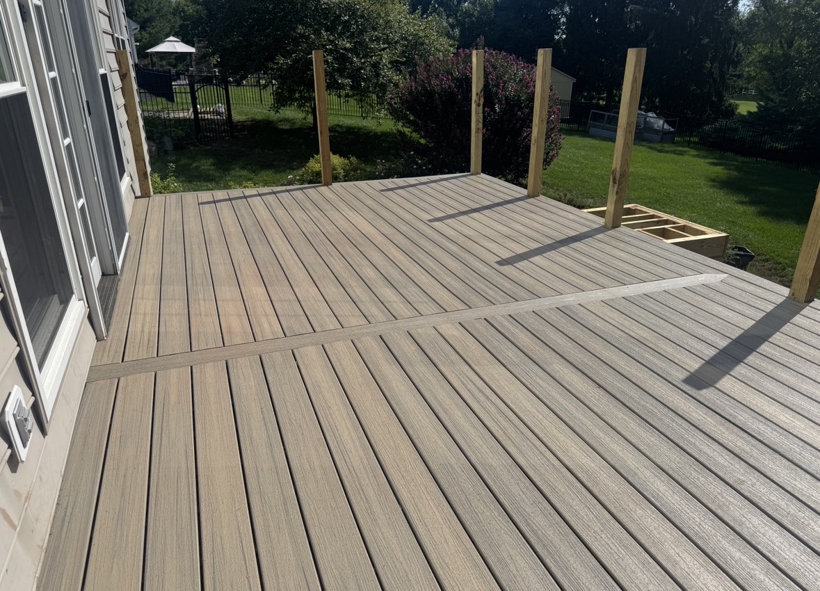 New composite decking installed with pergola posts set in place